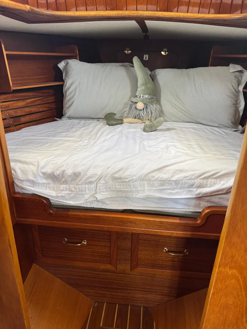 Slide: The Image of Cozy cabin bed in 1984 Ohlson 38 sailboat with decorative gnome. - 35
