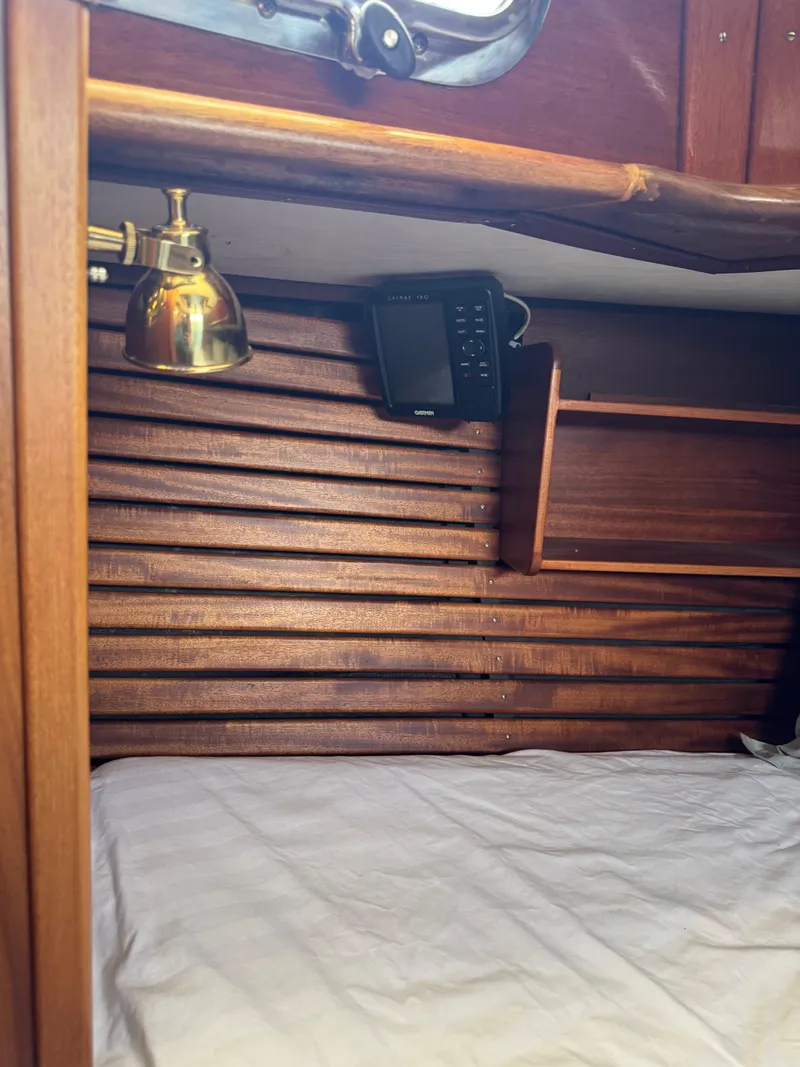 Slide: The Image of Cozy cabin interior of 1984 Ohlson 38 sailboat with wooden paneling and brass lamp. - 36
