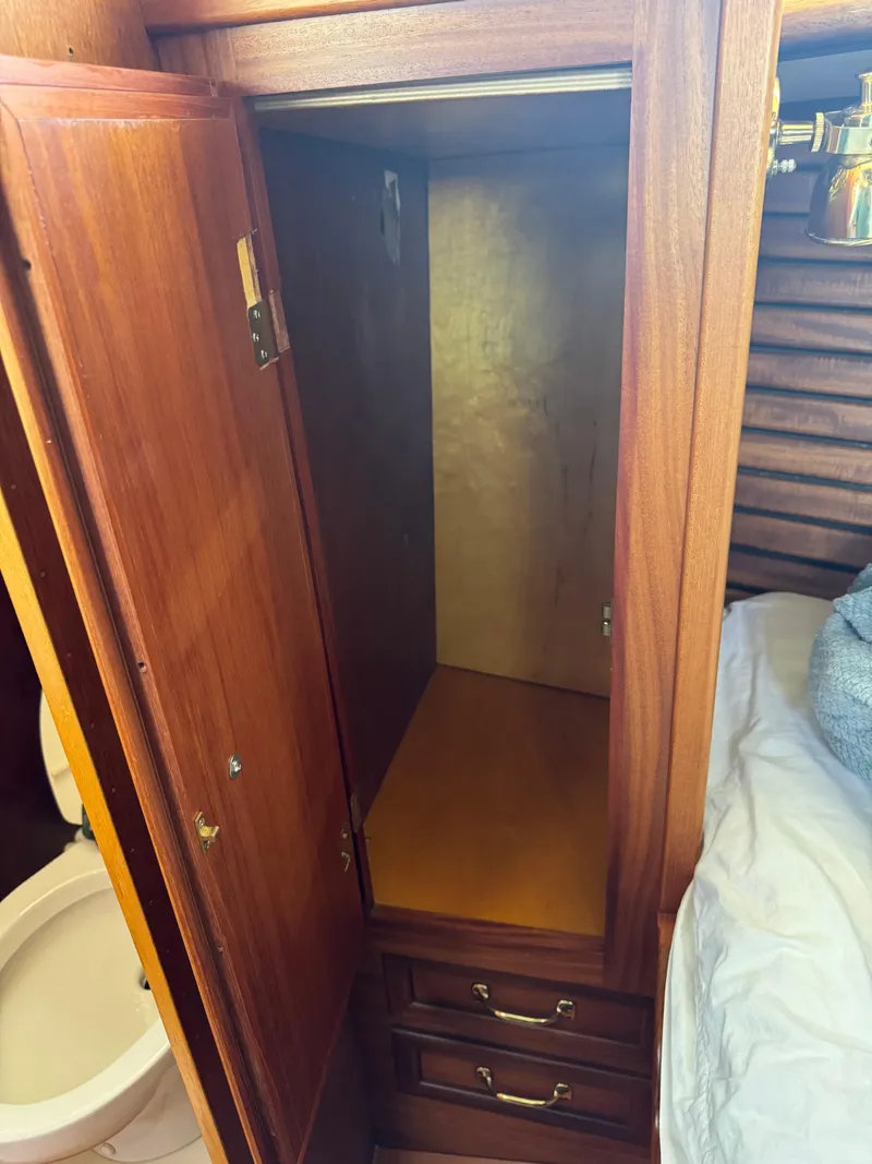 Slide: The Image of Wooden closet interior on 1984 Ohlson 38 yacht, next to bed and bathroom. - 39