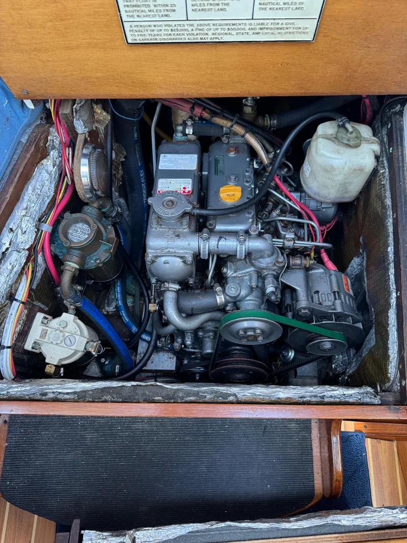 Slide: The Image of Engine compartment of a 1984 Ohlson 38 sailboat, showing mechanical components and wiring. - 41