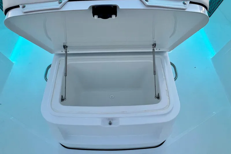 Slide: The Image of Open storage compartment on 2024 Wellcraft 352 Fisherman boat, featuring sturdy hinges and spacious interior. - 12