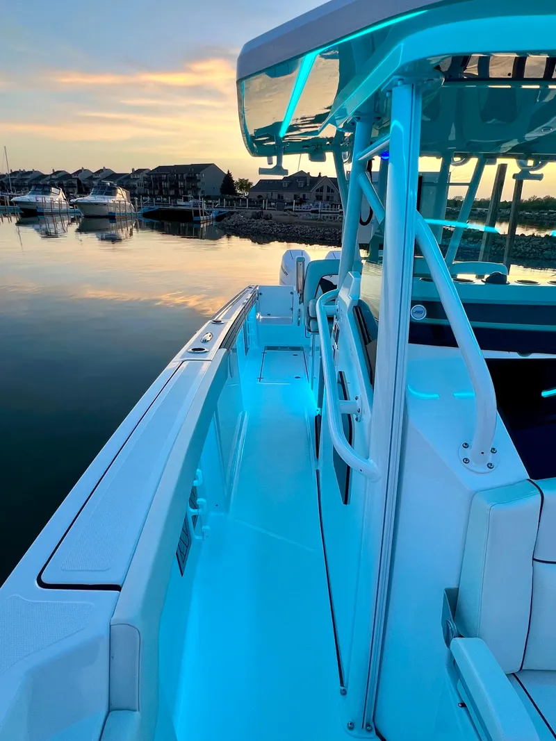 Slide: The Image of 2024 Wellcraft 352 Fisherman boat at sunset, featuring sleek design and ambient lighting. - 14