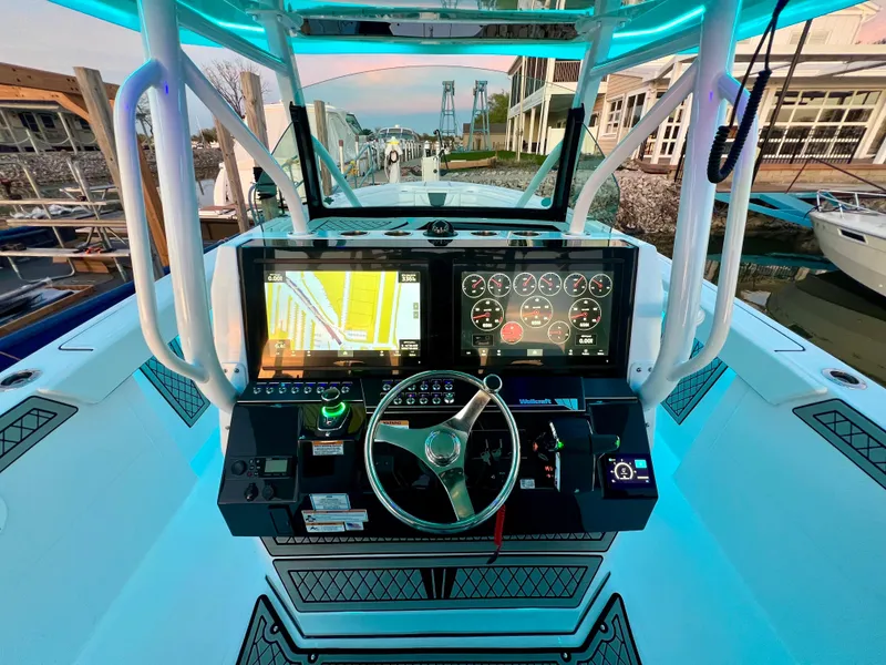 Slide: The Image of 2024 Wellcraft 352 Fisherman boat dashboard with advanced navigation and control systems. - 15