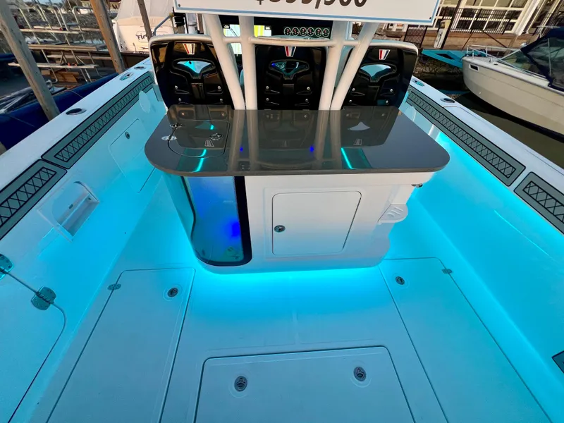 Slide: The Image of 2024 Wellcraft 352 Fisherman boat interior with blue LED lighting and modern console. - 18