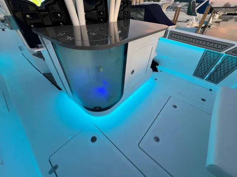 Slide: The Image of 2024 Wellcraft 352 Fisherman boat interior with blue LED lighting and sleek design. - 19