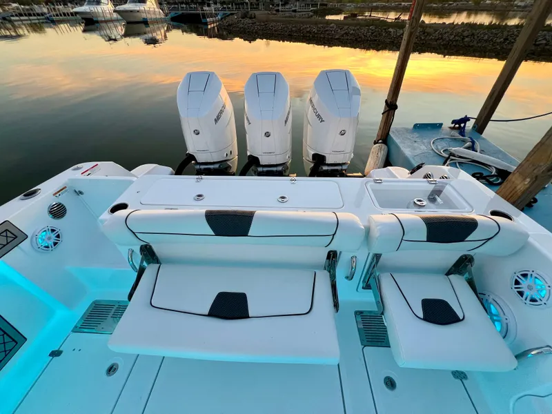 Slide: The Image of 2024 Wellcraft 352 Fisherman boat with triple outboard engines at sunset. - 20