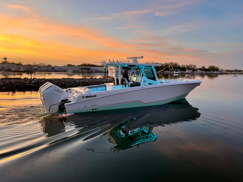 Slide: The Image of 2024 Wellcraft 352 Fisherman boat cruising at sunset on calm water. - 4