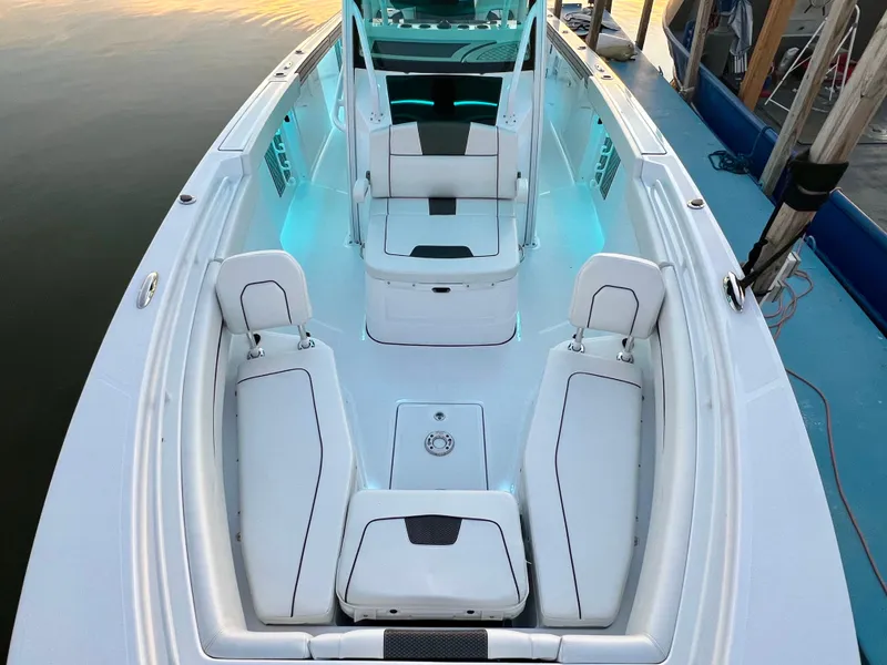 Slide: The Image of 2024 Wellcraft 352 Fisherman boat interior with white seating and ambient lighting. - 8