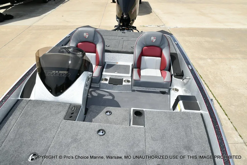 Slide: The Image of 2024 Triton 18 TRX boat interior with dual seats and steering console. - 11
