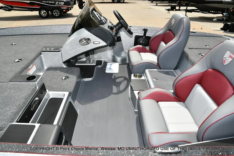 Slide: The Image of 2024 Triton 18 TRX boat interior with red and gray seating, dashboard, and storage compartments. - 13