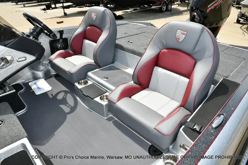 Slide: The Image of 2024 Triton 18 TRX boat interior with dual seats and steering wheel. - 14