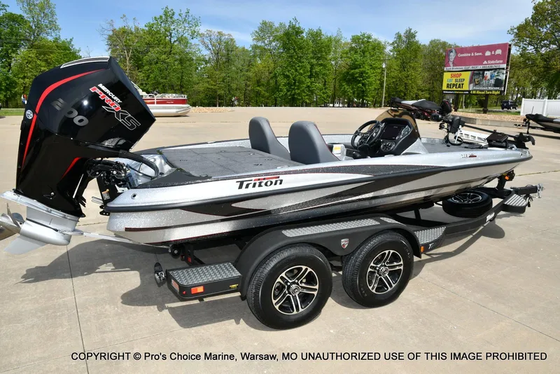Slide: The Image of 2024 Triton 18 TRX boat with 200 Pro-XS engine on trailer, parked outdoors. - 16