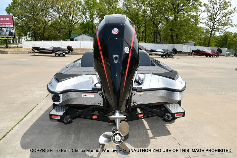 Slide: The Image of 2024 Triton 18 TRX boat with 200 Pro-XS engine, rear view in outdoor setting. - 23