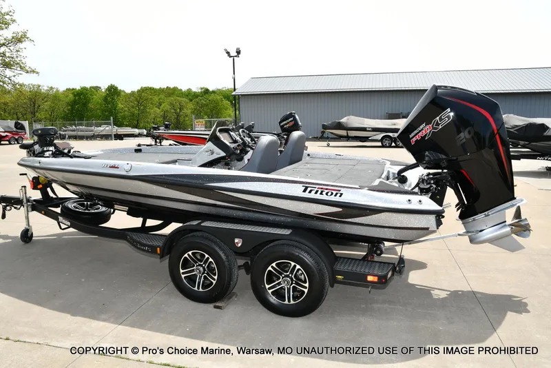 Slide: The Image of 2024 Triton 18 TRX boat with 200 Pro-XS engine on trailer, parked outdoors. - 25