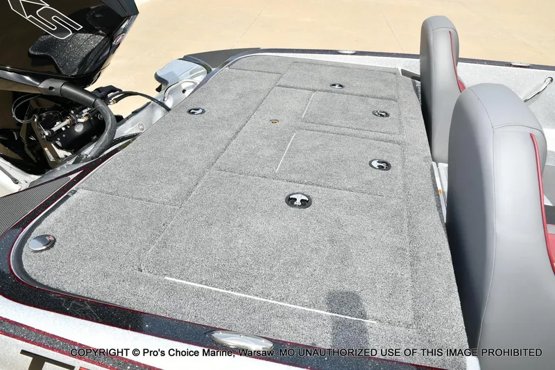 Slide: The Image of 2024 Triton 18 TRX boat deck with gray carpet and seating. - 35