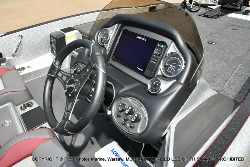 Slide: The Image of 2024 Triton 18 TRX boat dashboard with steering wheel and digital display. - 36