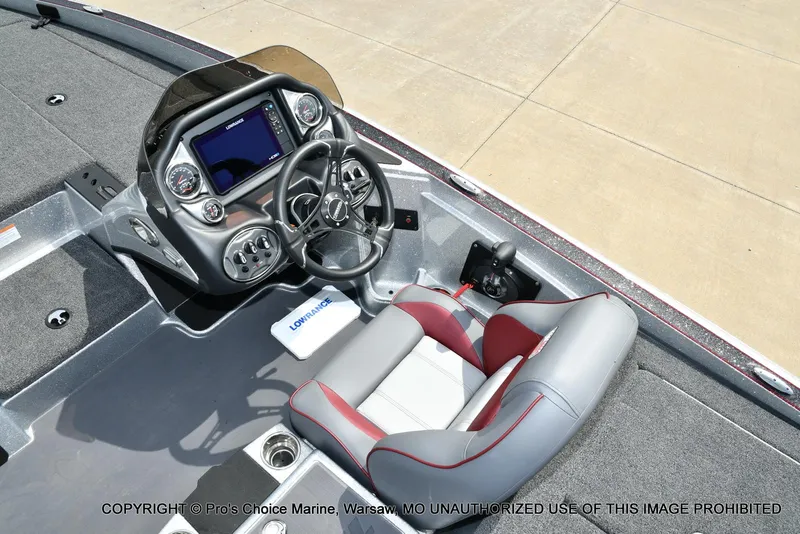 Slide: The Image of 2024 Triton 18 TRX boat interior with steering console and seating. - 39