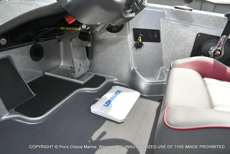 Slide: The Image of 2024 Triton 18 TRX boat interior with Lowrance equipment and comfortable seating. - 42