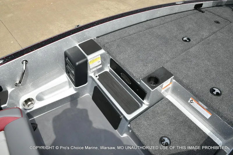 Slide: The Image of 2024 Triton 18 TRX boat interior with carpeted deck and storage compartments. - 44