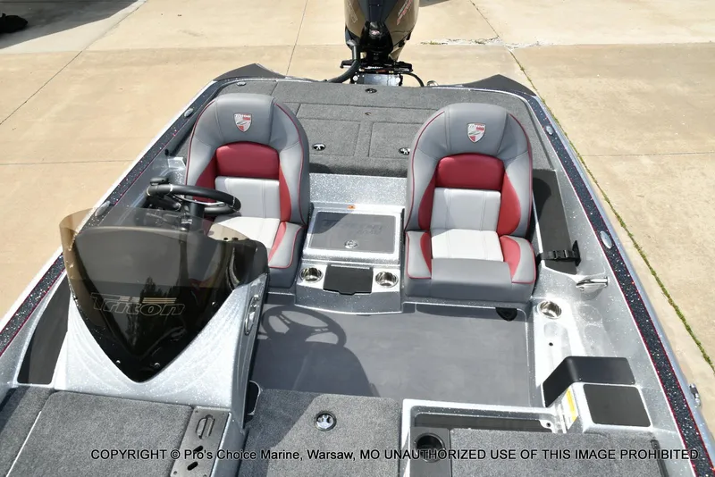 Slide: The Image of 2024 Triton 18 TRX boat interior with dual seats and steering console. - 47