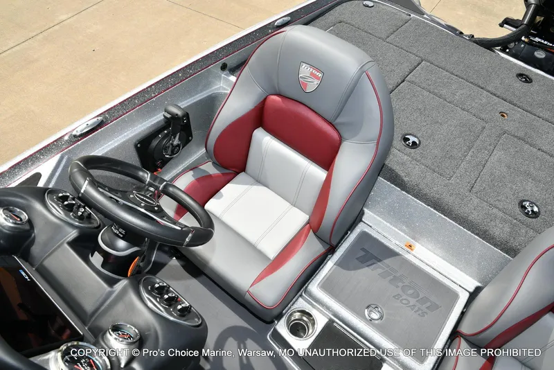 Slide: The Image of 2024 Triton 18 TRX boat interior with steering wheel and seating. - 49