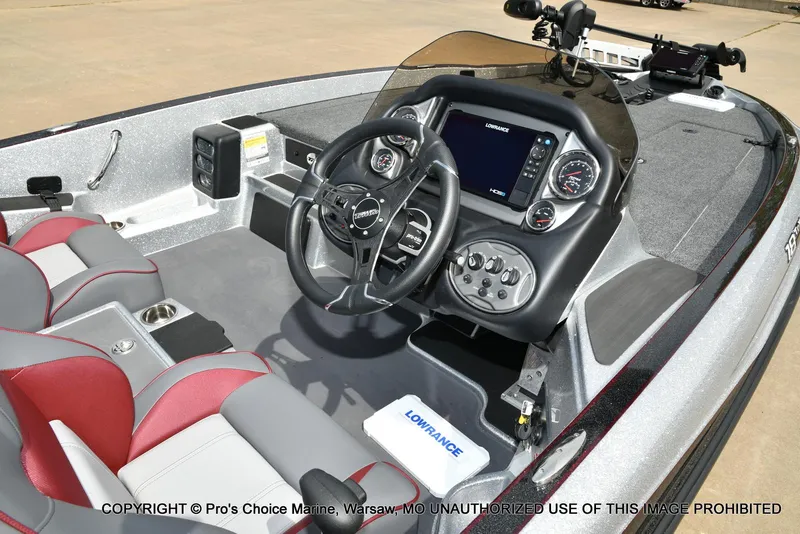 Slide: The Image of 2024 Triton 18 TRX boat interior with steering wheel, dashboard, and seating. - 6