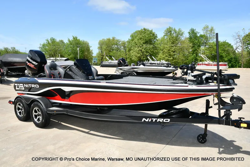 Slide: The Image of 2018 Nitro Z19 Pro Pack boat with trailer, parked outdoors on a sunny day. - 1