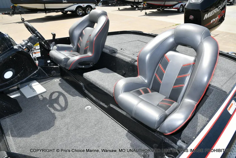 Slide: The Image of 2018 Nitro Z19 Pro Pack boat interior with sleek, modern seating and steering wheel. - 15