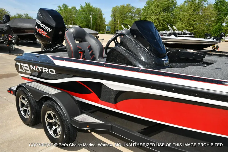 Slide: The Image of 2018 Nitro Z19 Pro Pack boat with Mercury engine, parked on a trailer. - 16