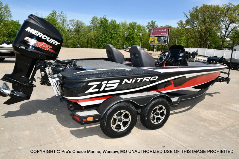 Slide: The Image of 2018 Nitro Z19 Pro Pack boat with Mercury engine, parked outdoors on a sunny day. - 18