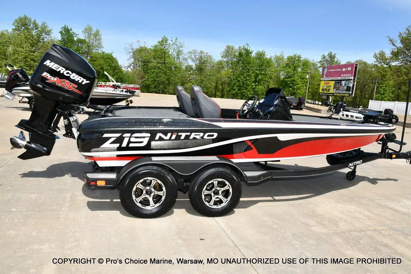 Slide: The Image of 2018 Nitro Z19 Pro Pack boat with Mercury engine on a trailer. - 19