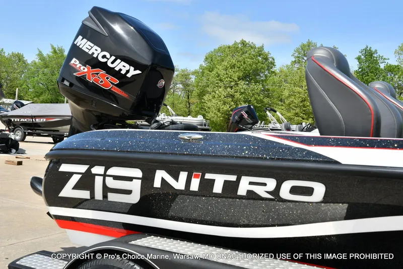 Slide: The Image of 2018 Nitro Z19 Pro Pack boat with Mercury Pro XS engine, parked outdoors. - 2