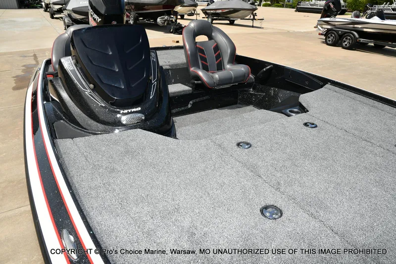 Slide: The Image of 2018 Nitro Z19 Pro Pack boat with gray carpet and seating, displayed outdoors. - 39