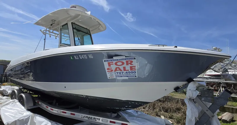 The Image of 2013 Boston Whaler 280 Outrage boat for sale, displayed on a trailer. - 0