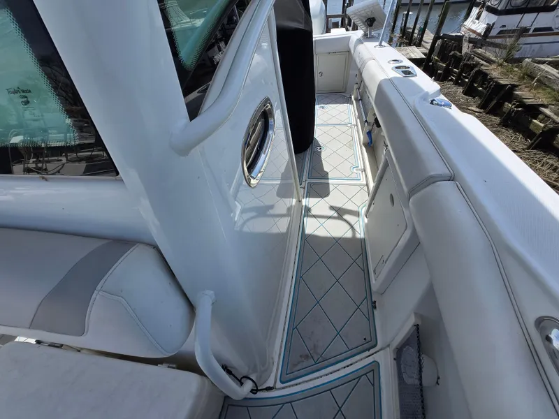 Slide: The Image of 2013 Boston Whaler 280 Outrage boat interior with white seating and deck details. - 10