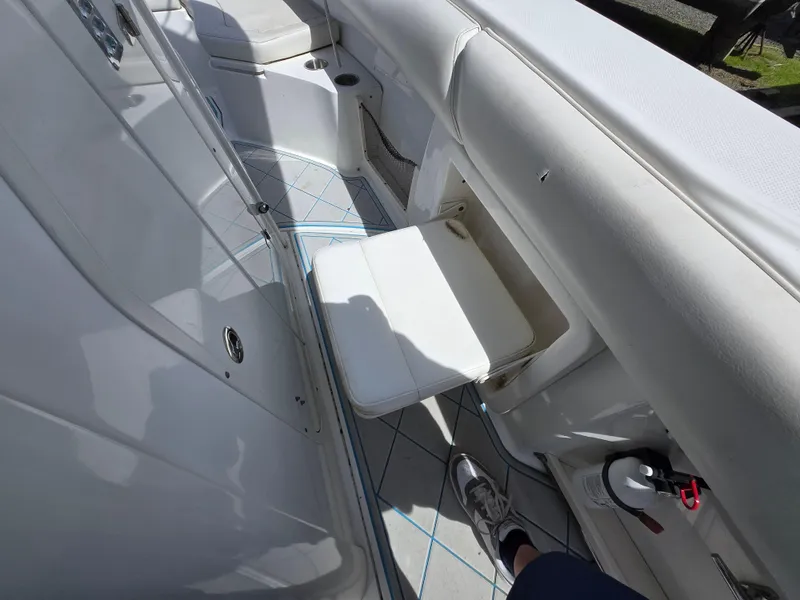 Slide: The Image of 2013 Boston Whaler 280 Outrage interior with white seating and deck details. - 12