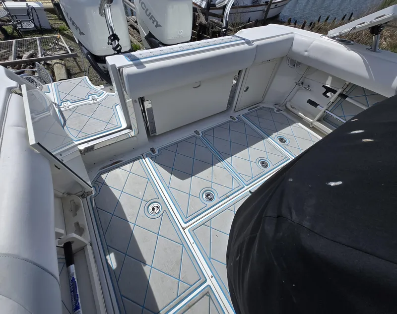 Slide: The Image of 2013 Boston Whaler 280 Outrage boat deck with storage compartments and seating. - 13