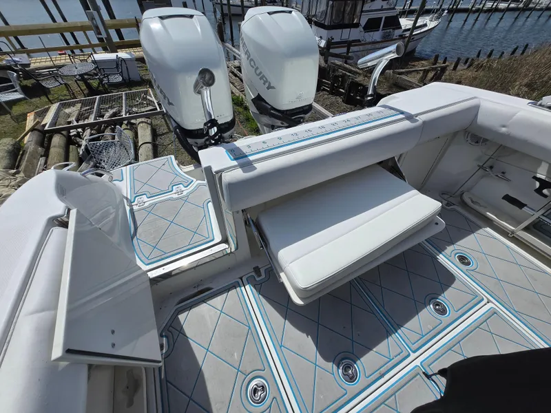 Slide: The Image of 2013 Boston Whaler 280 Outrage boat interior with seating and twin Mercury engines. - 14
