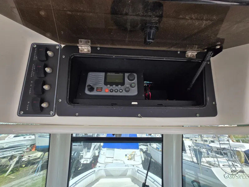 Slide: The Image of 2013 Boston Whaler 280 Outrage dashboard with radio and control panel. - 21