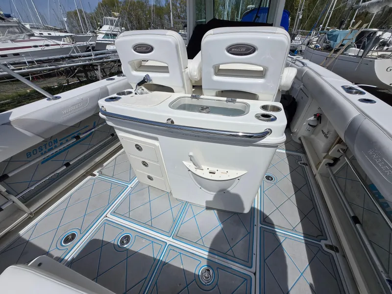 Slide: The Image of 2013 Boston Whaler 280 Outrage boat interior with seating and storage compartments. - 23