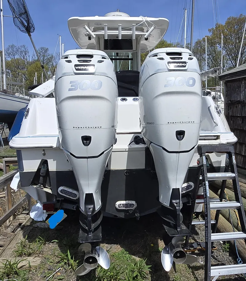 Slide: The Image of 2013 Boston Whaler 280 Outrage with twin 300 horsepower engines, docked outdoors. - 25