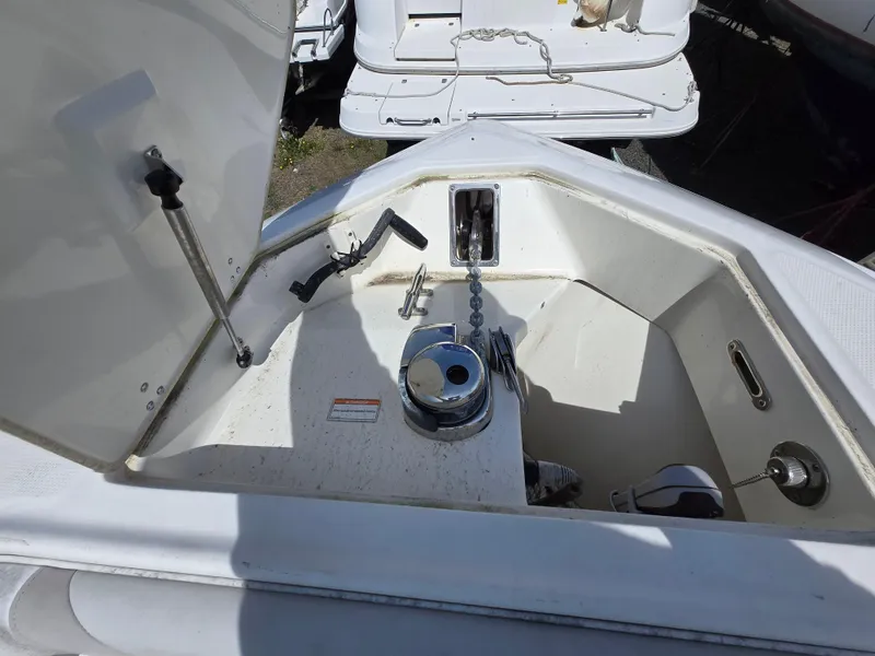 Slide: The Image of 2013 Boston Whaler 280 Outrage anchor compartment with chain and winch. - 26