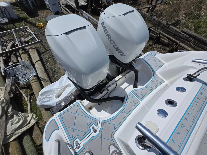 Slide: The Image of Boston Whaler 280 Outrage 2013 with dual Mercury outboard engines, docked outdoors. - 4