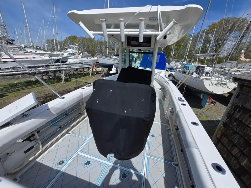 Slide: The Image of 2013 Boston Whaler 280 Outrage boat docked, featuring spacious deck and modern design. - 9