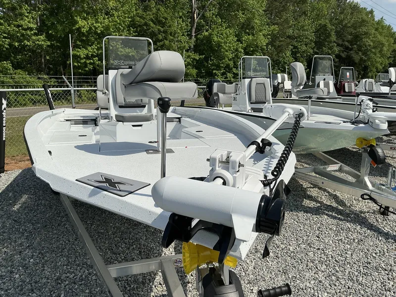 Slide: The Image of 2025 Xpress Hyper-Lift Series H22B boat displayed outdoors on gravel. - 2