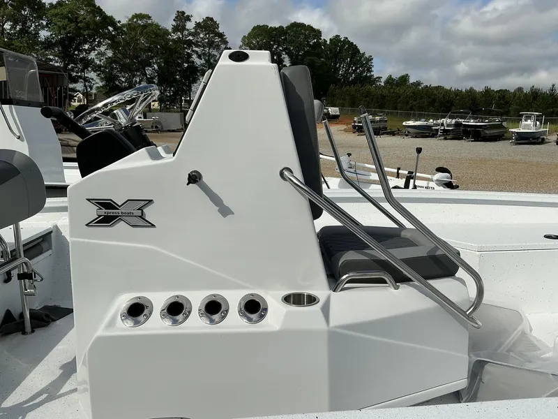 Slide: The Image of 2025 Xpress Hyper-Lift Series H22B boat console with seating, stainless steel rails, and cup holders. - 9