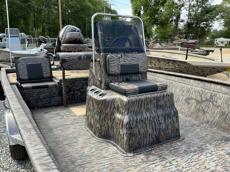 Slide: The Image of 2025 Xpress Xplorer Series XP20CC boat with camouflage design, featuring center console and seating. - 7