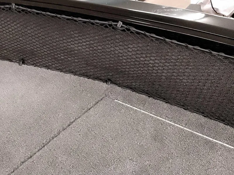 Slide: The Image of 2025 Ranger VS1782SC Angler boat interior with black netting and gray carpeted flooring. - 11