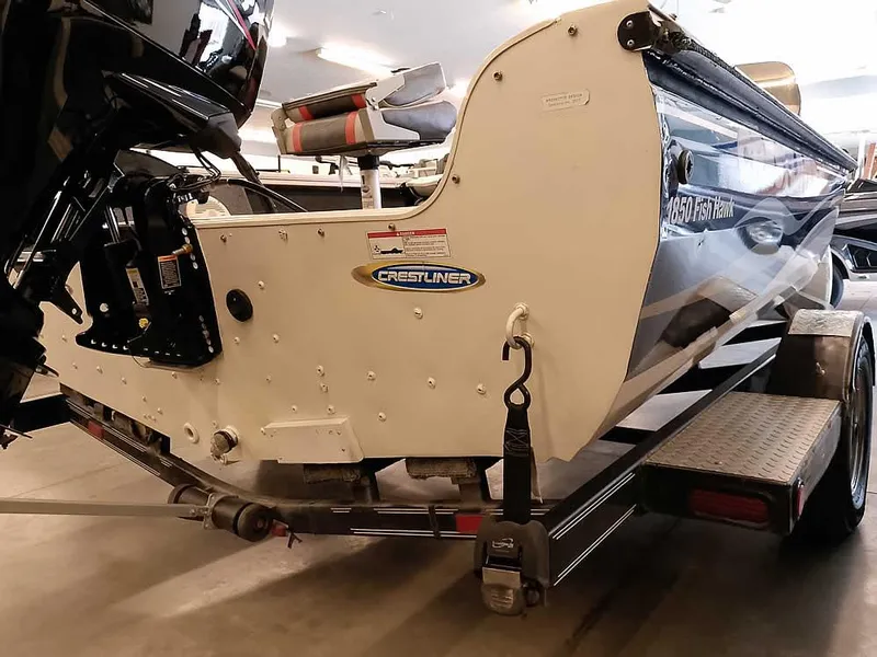 Slide: The Image of 2006 Crestliner 1850 Fish Hawk DC boat on trailer, rear view in indoor setting. - 11