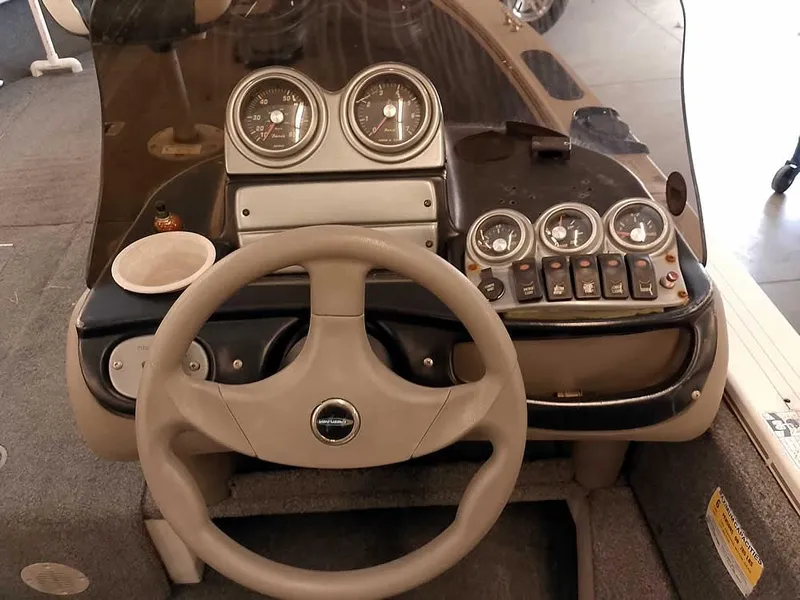 Slide: The Image of Dashboard of 2006 Crestliner 1850 Fish Hawk DC boat with steering wheel and gauges. - 28